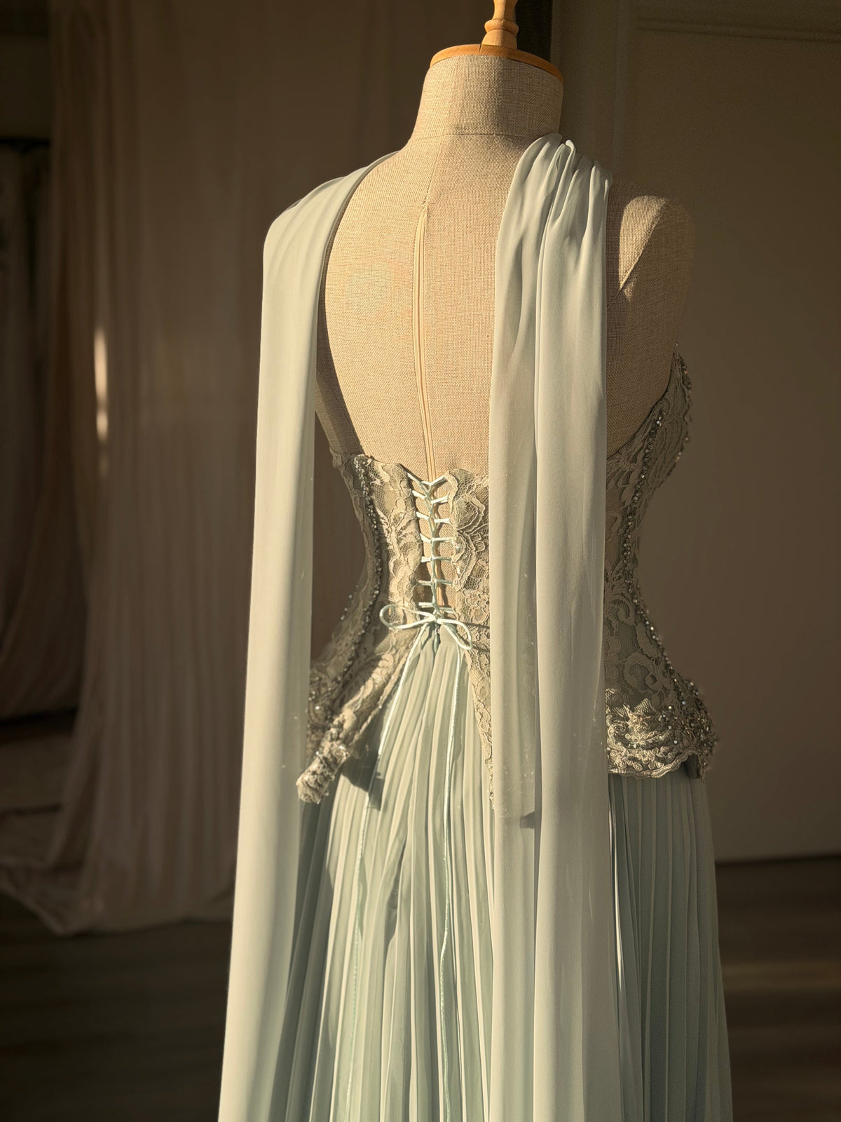 Pleated Gown with Embellished Corset and Cape